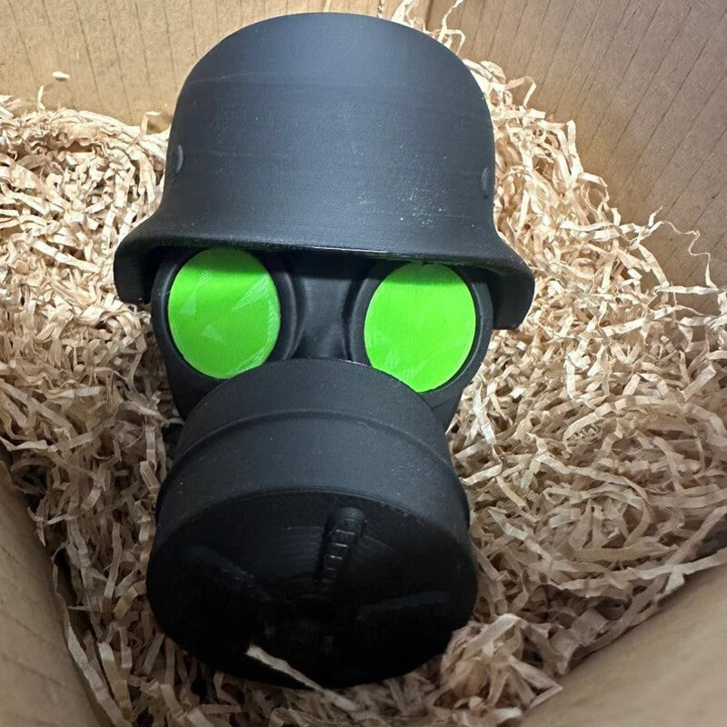 3D - printed trailer hitch cover with steel helmet and gas mask design. Protects the receiver tube from rusting.
